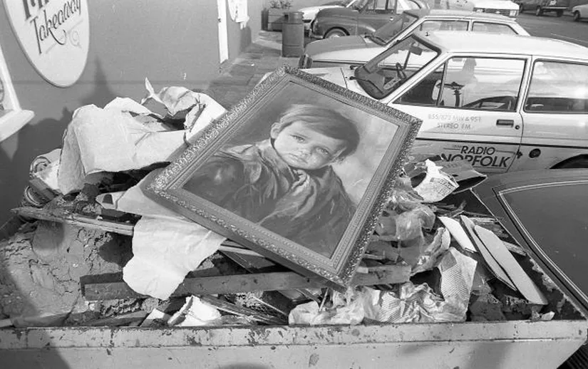 The Crying Boy painting in a dumpster